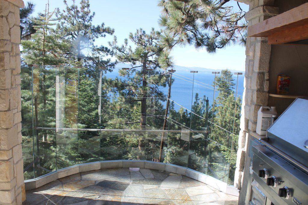 Glass panels and stonework detail on the lakefront estate project
