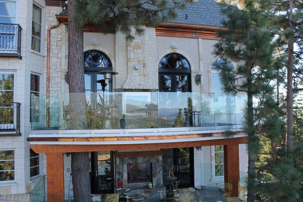 Frameless glass railing on a copper-trimmed Tahoe lakefront balcony — Lake Tahoe Glass